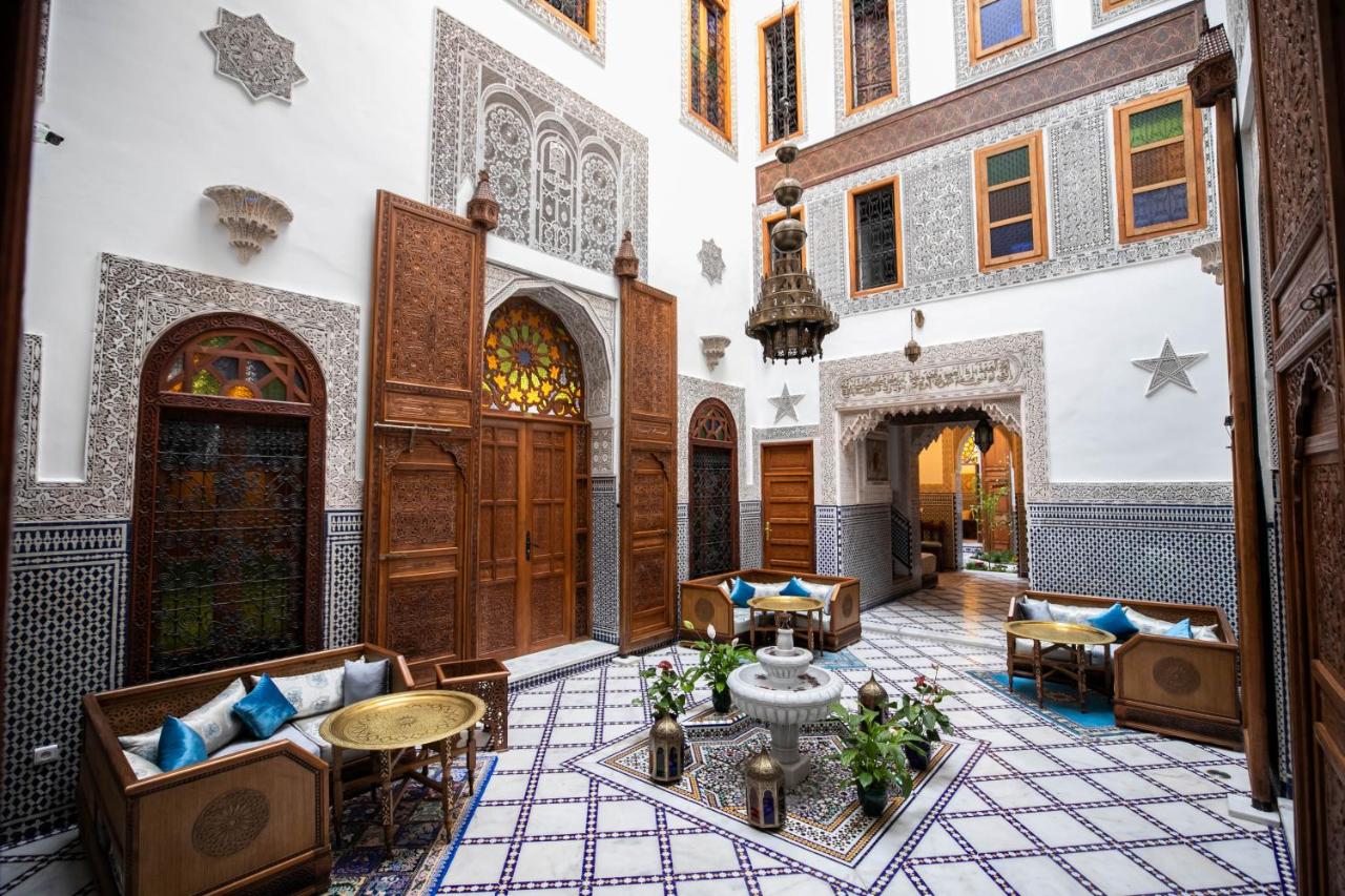 The lounge with low sofas, fountain and high arched ceilings