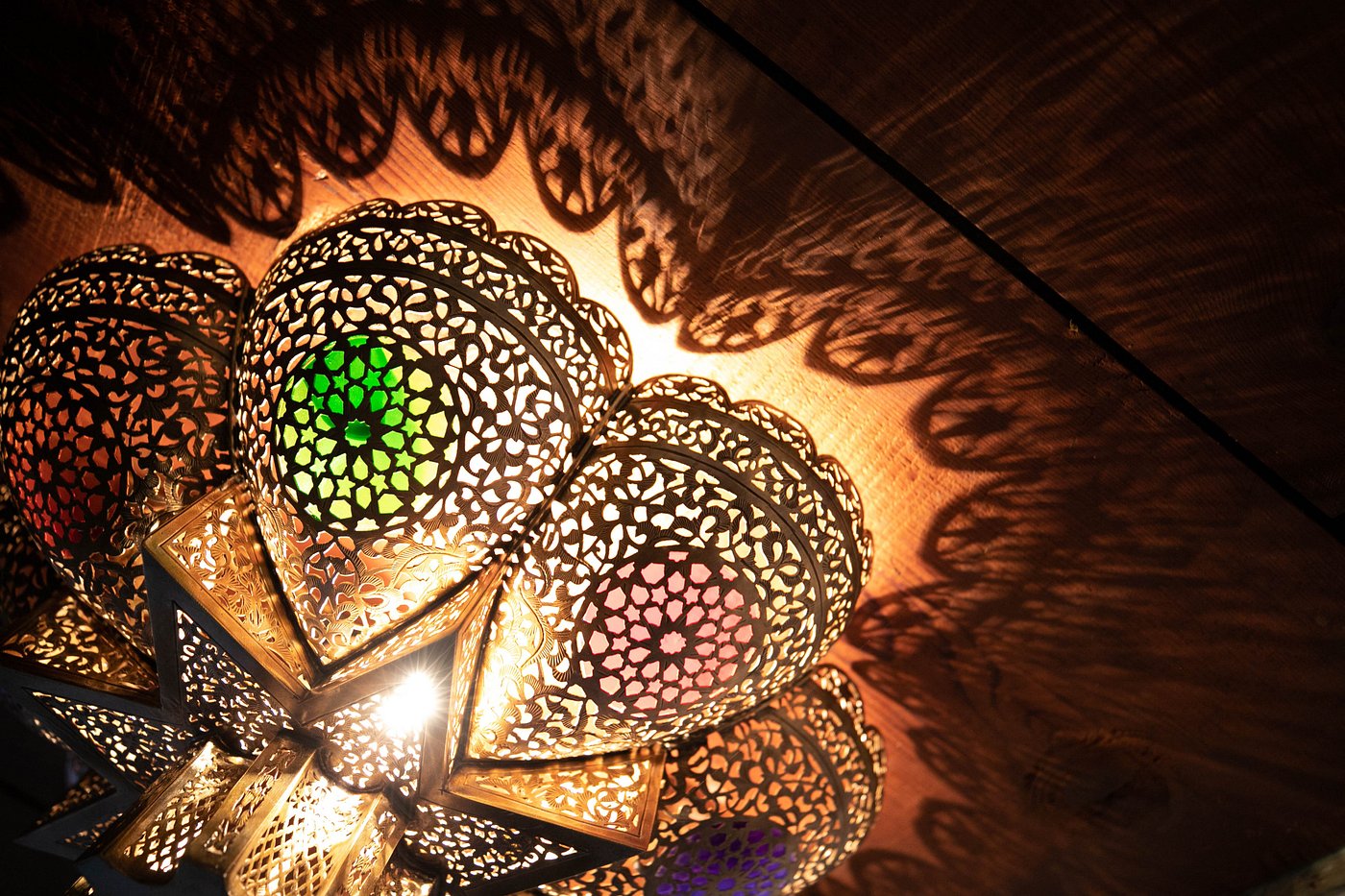 A perforated brass lantern casting warm light